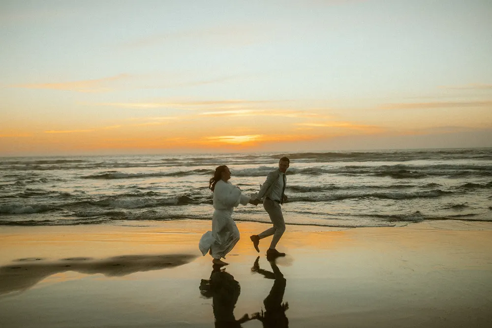 Running together at the ocean at sunset