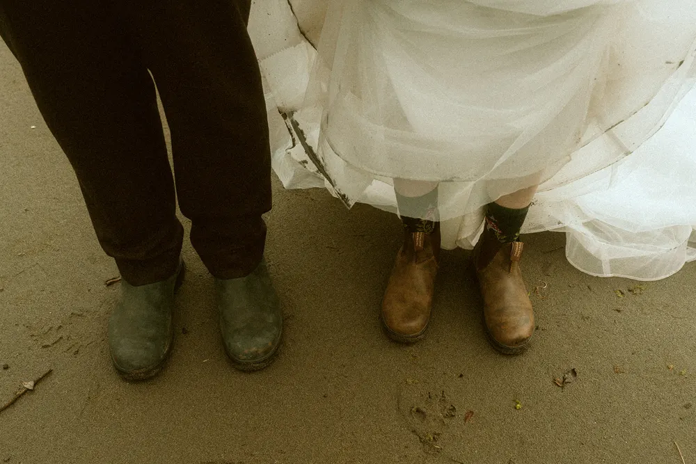 Wedding clothes and boots on the sand