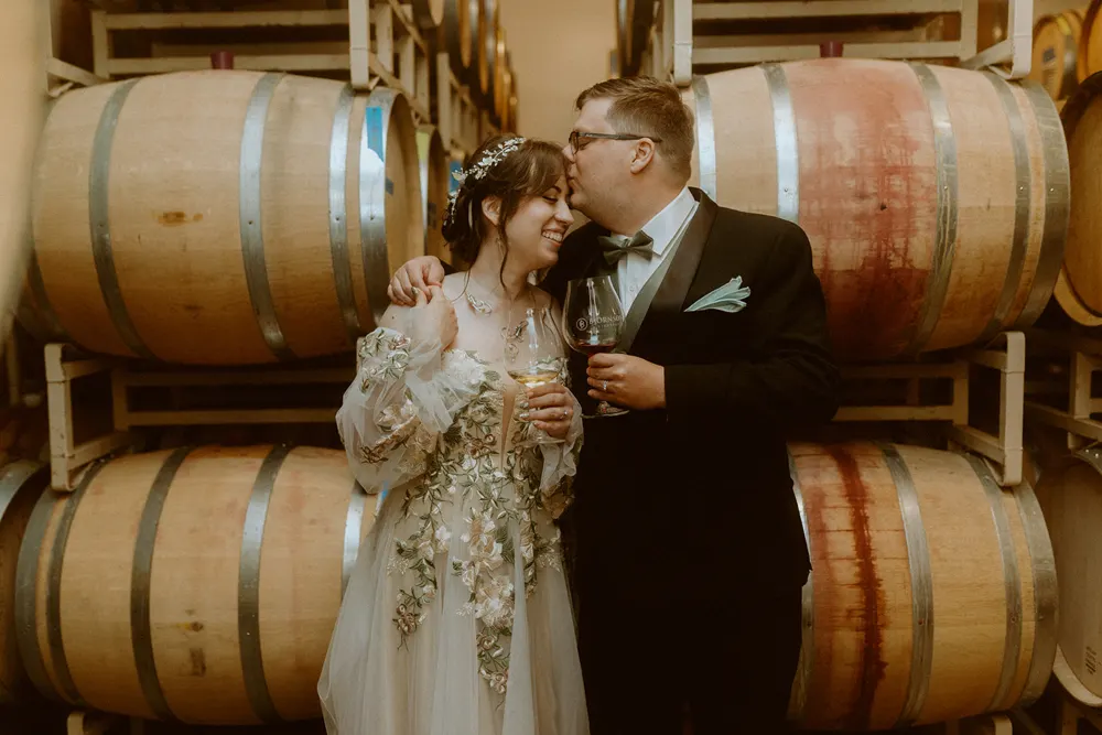 A kiss beside the wine barrels