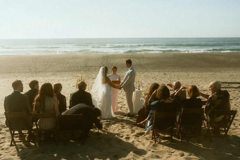 Beach ceremony surrounded by friends and family